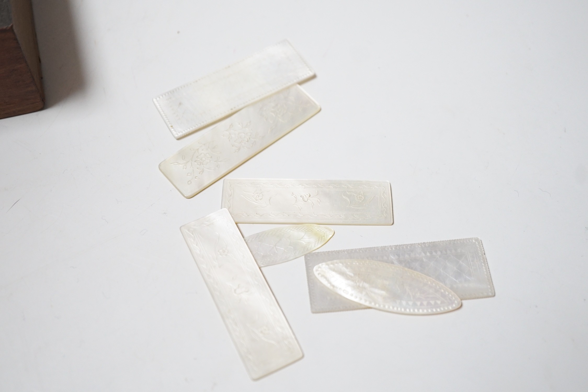 A collection of engraved mother of pearl gaming counters